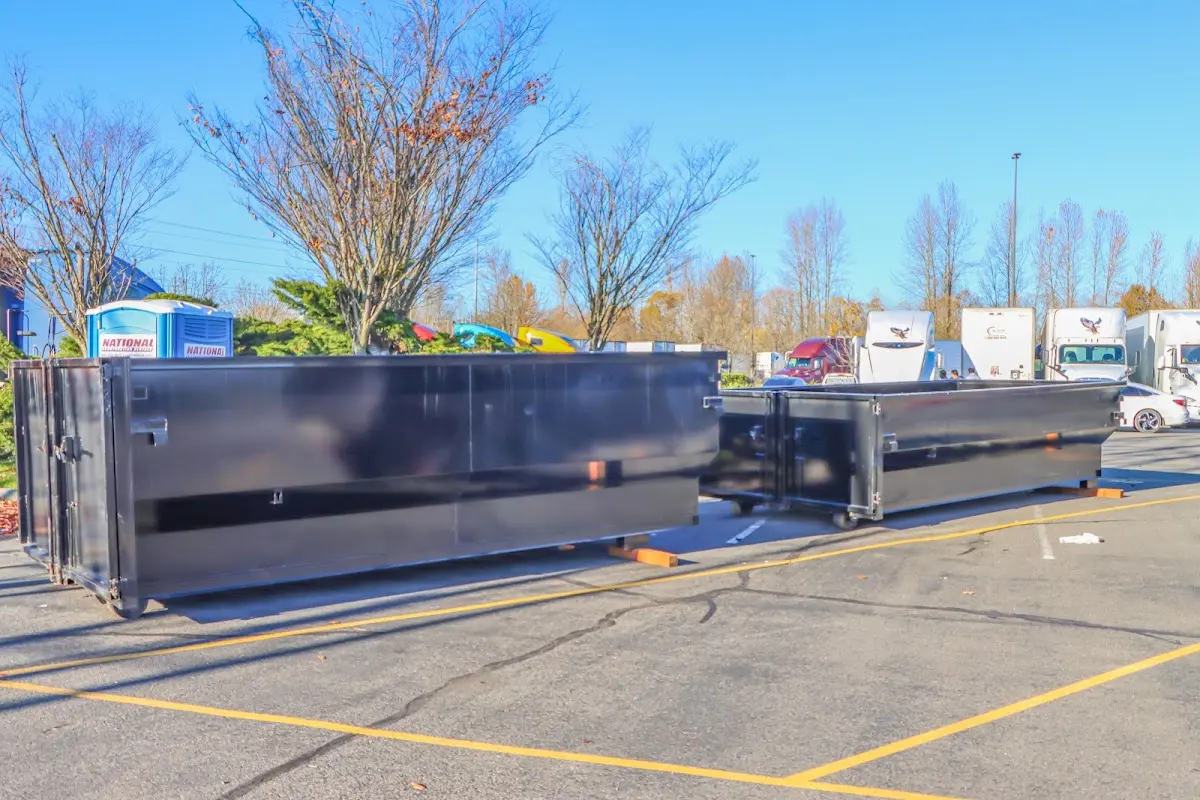 Professional dumpster rental service with roll-off container on residential driveway in St. Joseph